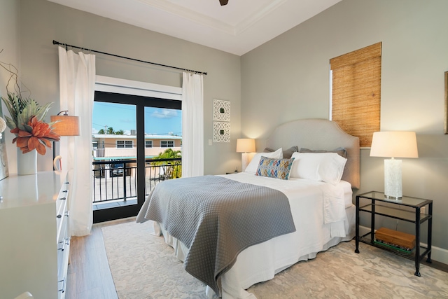 bedroom with access to exterior and light wood-type flooring