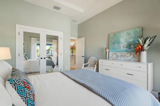 bedroom with crown molding and french doors