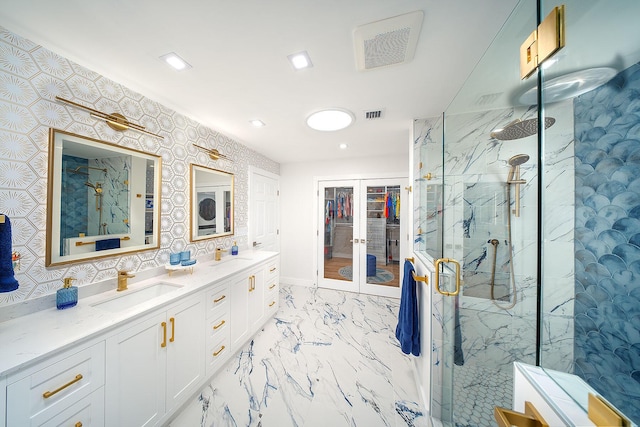 bathroom featuring a shower with door, vanity, and french doors