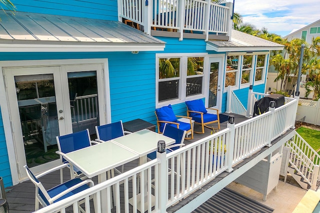 wooden terrace featuring french doors and area for grilling