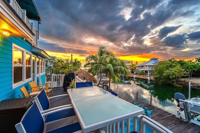 exterior space with a dock and a water view