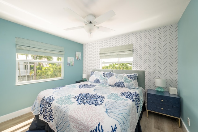 bedroom with wood-type flooring and ceiling fan