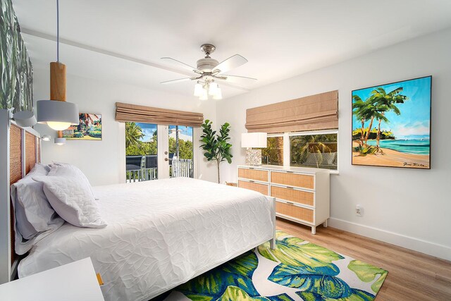 bedroom with hardwood / wood-style flooring, ceiling fan, and access to exterior