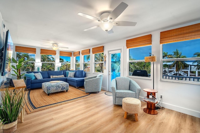 sunroom featuring ceiling fan