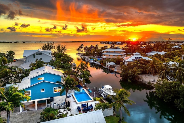 aerial view at dusk with a water view