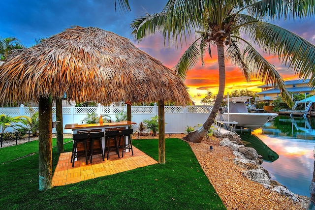 yard at dusk featuring a patio