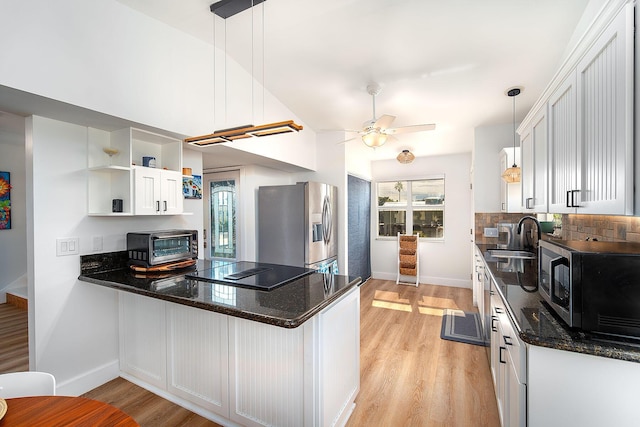 kitchen with pendant lighting, sink, white cabinetry, stainless steel appliances, and kitchen peninsula