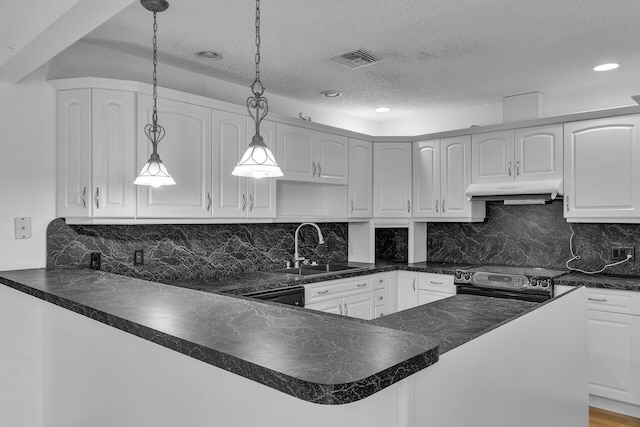 kitchen featuring dark countertops, stainless steel electric range oven, and decorative light fixtures