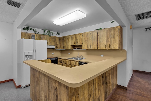 kitchen with white refrigerator with ice dispenser, light countertops, stove, a sink, and a peninsula