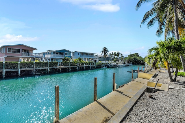 view of dock with a water view and a residential view