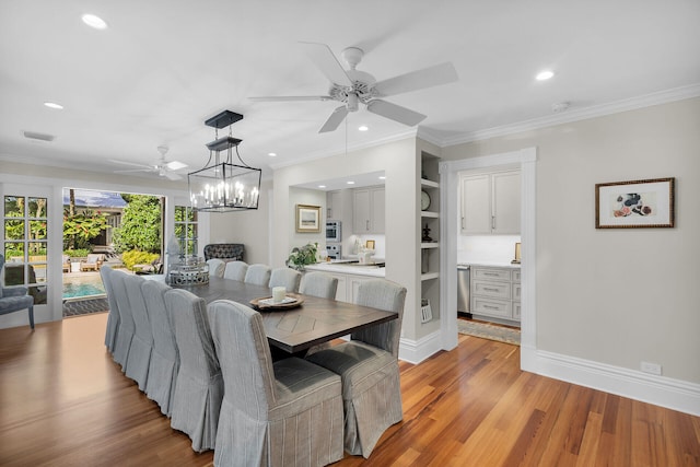 1109 Fleming St, Key West, FL 33040 - dining area with a ceiling fan, light wood-style flooring, recessed lighting, ornamental molding, and a chandelier