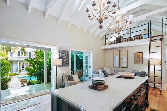 1109 Fleming St, Key West, FL 33040 - kitchen with high vaulted ceiling, light wood-style floors, a chandelier, open floor plan, and beamed ceiling