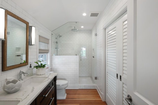 1109 Fleming St, Key West, FL 33040 - bathroom with a shower stall, wood finished floors, double vanity, toilet, and vaulted ceiling