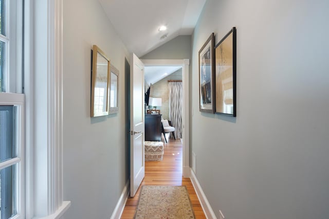 1109 Fleming St, Key West, FL 33040 - hallway featuring light wood finished floors, vaulted ceiling, and baseboards