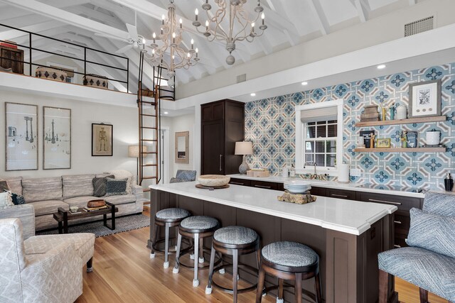 1109 Fleming St, Key West, FL 33040 - kitchen featuring open floor plan, wallpapered walls, light countertops, dark brown cabinets, and beam ceiling
