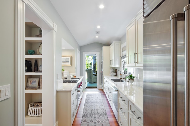 1109 Fleming St, Key West, FL 33040 - kitchen with appliances with stainless steel finishes, vaulted ceiling, white cabinets, recessed lighting, and dark wood finished floors