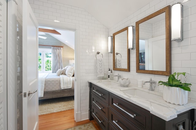 1109 Fleming St, Key West, FL 33040 - ensuite bathroom with vaulted ceiling, wood finished floors, double vanity, and tile walls