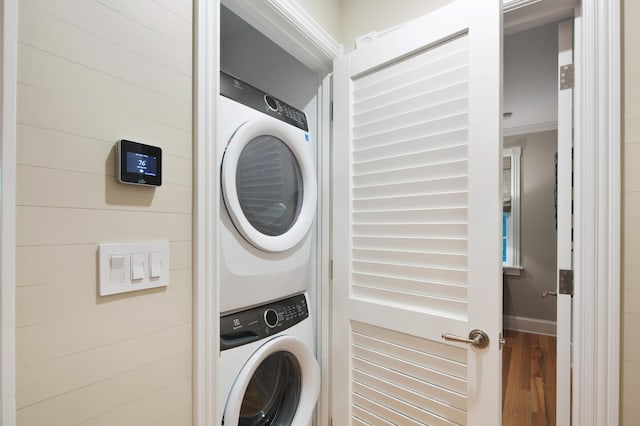 1109 Fleming St, Key West, FL 33040 - laundry room with stacked washing machine and dryer and wood finished floors