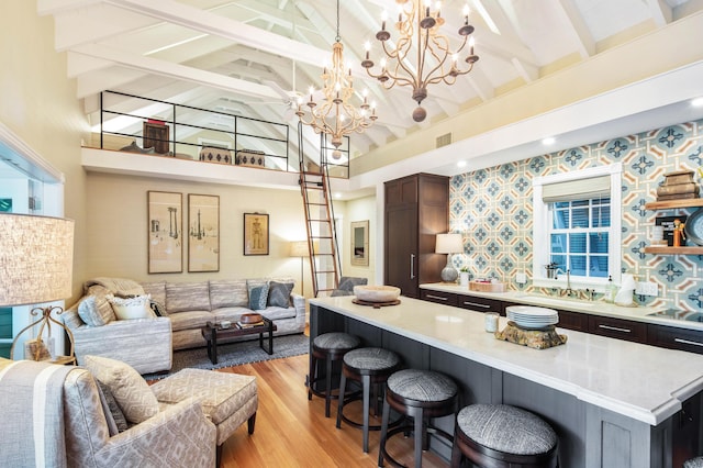 1109 Fleming St, Key West, FL 33040 - bar area with beamed ceiling, light wood-style floors, a sink, a chandelier, and wallpapered walls