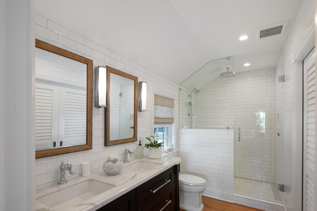 1109 Fleming St, Key West, FL 33040 - bathroom with tile walls, a stall shower, toilet, double vanity, and lofted ceiling