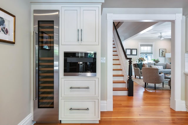 1109 Fleming St, Key West, FL 33040 - bar area with wine cooler, light wood finished floors, stairs, and ceiling fan
