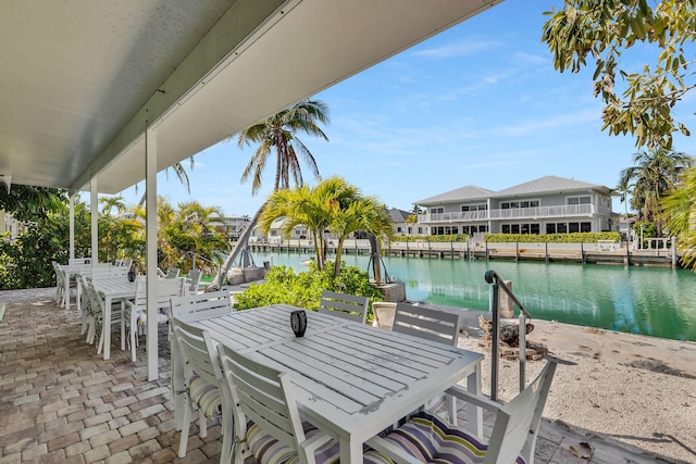 view of patio featuring outdoor dining space and a water view