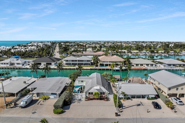 bird's eye view featuring a water view and a residential view