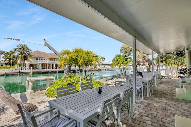 view of patio featuring a water view and a bar