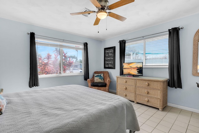 bedroom featuring ceiling fan, baseboards, and light tile patterned floors