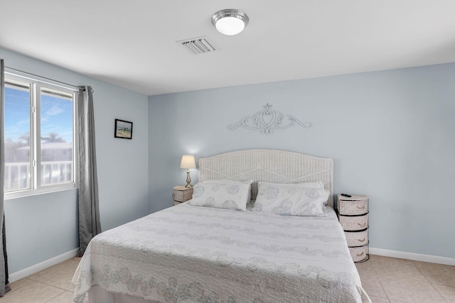 bedroom featuring visible vents, baseboards, and light tile patterned flooring