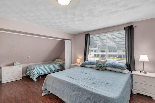 bedroom with dark wood-style flooring