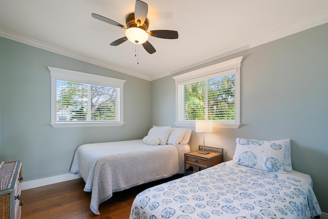 bedroom featuring crown molding, dark wood-type flooring, and ceiling fan