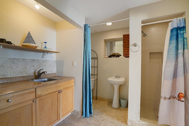 bathroom featuring sink, decorative backsplash, tile patterned floors, and walk in shower