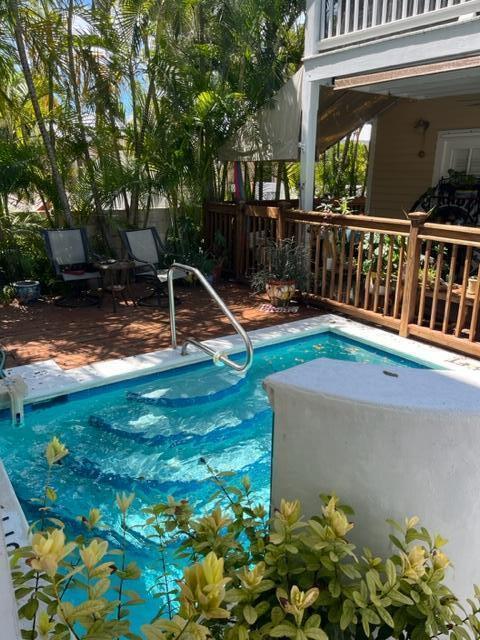 view of swimming pool with a patio and fence