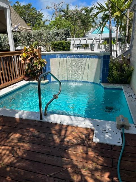 view of swimming pool featuring a deck and a fenced in pool