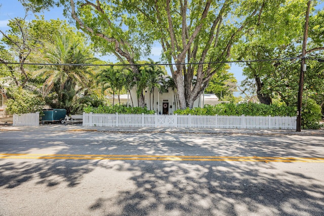 view of parking / parking lot featuring a fenced front yard