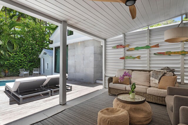 deck with an outdoor hangout area and a ceiling fan
