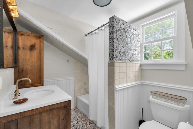 full bath with a wainscoted wall, toilet, and vanity