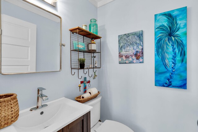 half bathroom featuring toilet and vanity