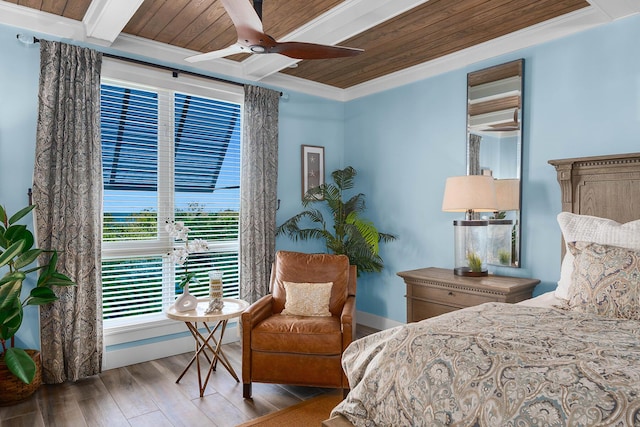 bedroom with crown molding, wooden ceiling, beamed ceiling, ceiling fan, and light hardwood / wood-style floors