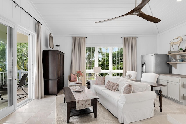 living room with lofted ceiling, a wealth of natural light, ornamental molding, and ceiling fan