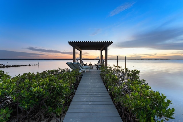 view of dock featuring a pergola and a water view