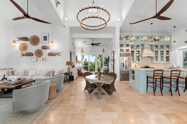 dining room with a high ceiling, crown molding, and ceiling fan