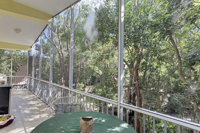 sunroom / solarium featuring outdoor dining space