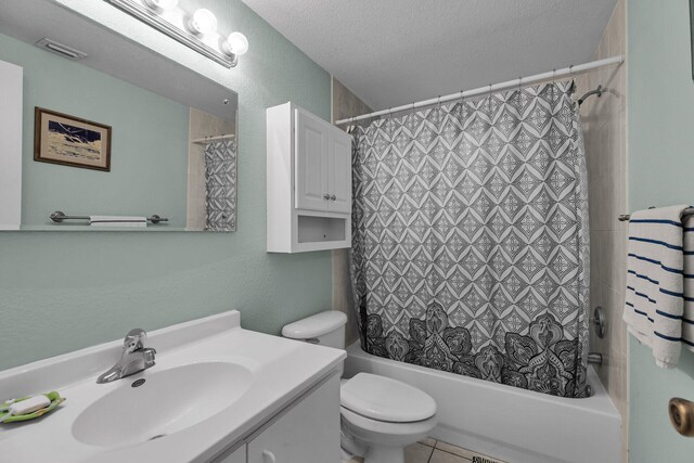 full bathroom with tile patterned flooring, vanity, toilet, shower / bath combo, and a textured ceiling