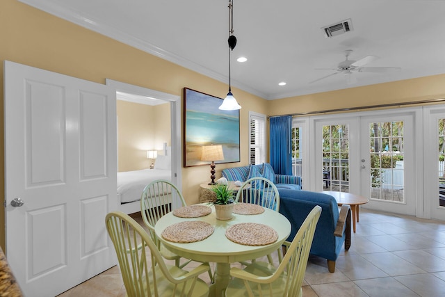 dining room featuring crown molding, light tile patterned floors, ceiling fan, and french doors