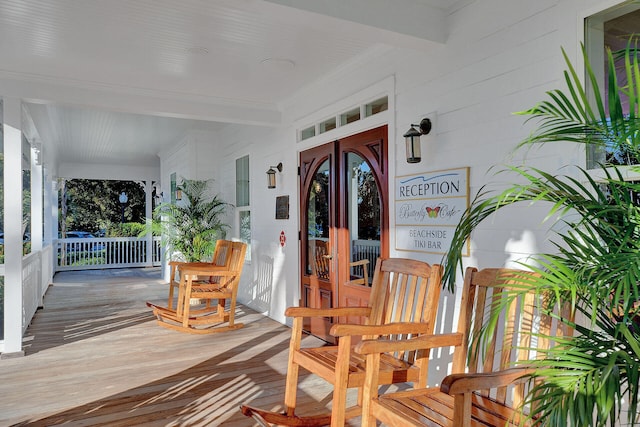 view of exterior entry with covered porch