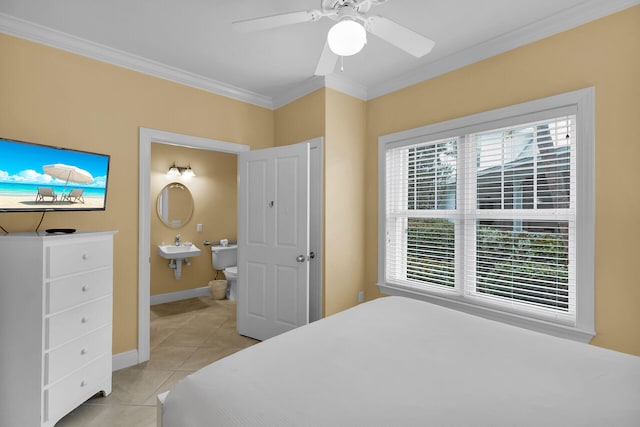 bedroom featuring ornamental molding, light tile patterned floors, ceiling fan, and ensuite bath