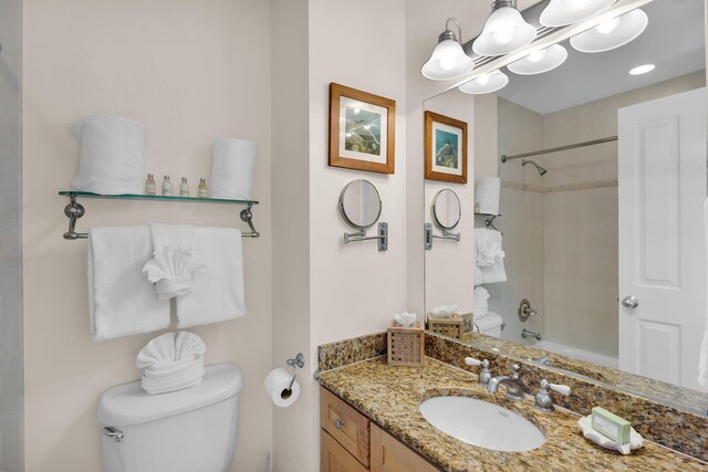 full bathroom featuring shower / bathing tub combination, vanity, and toilet