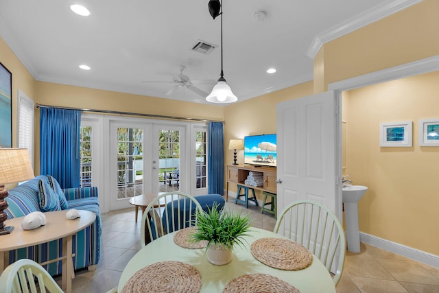 dining room featuring crown molding, plenty of natural light, light tile patterned floors, and french doors